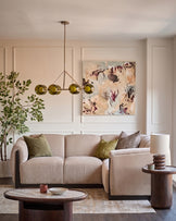 Champagne fabric right-hand small corner sofa in a modern living room setting with coordinating armchair and wooden accents.