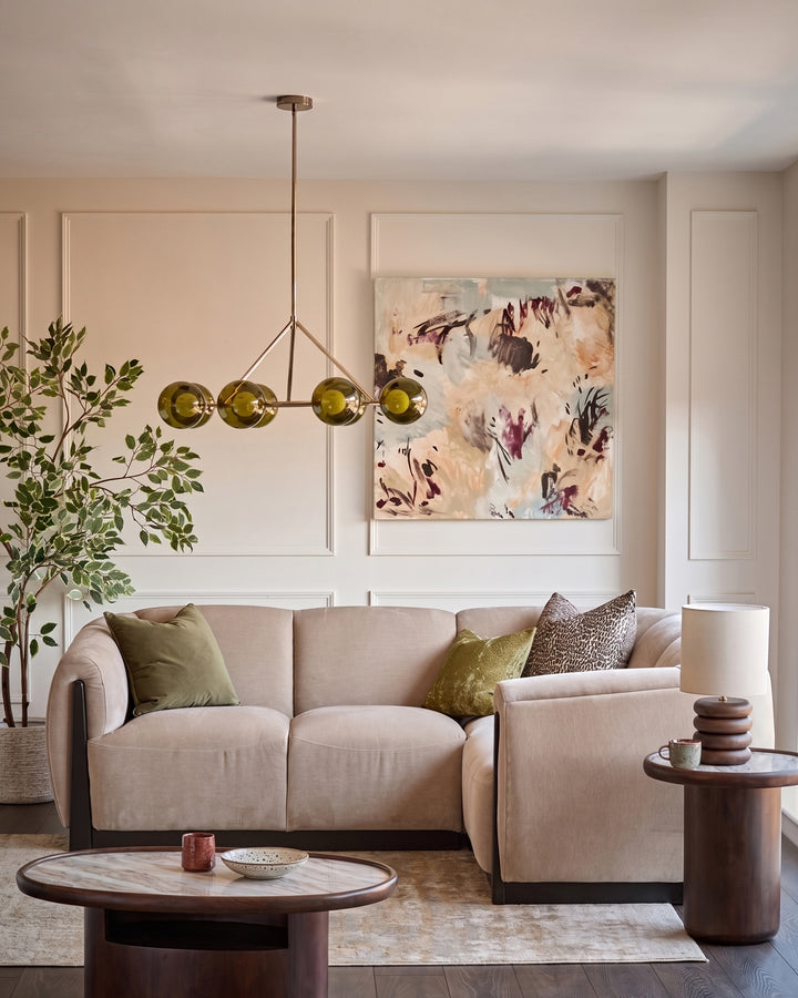 Champagne fabric right-hand small corner sofa in a modern living room setting with coordinating armchair and wooden accents.