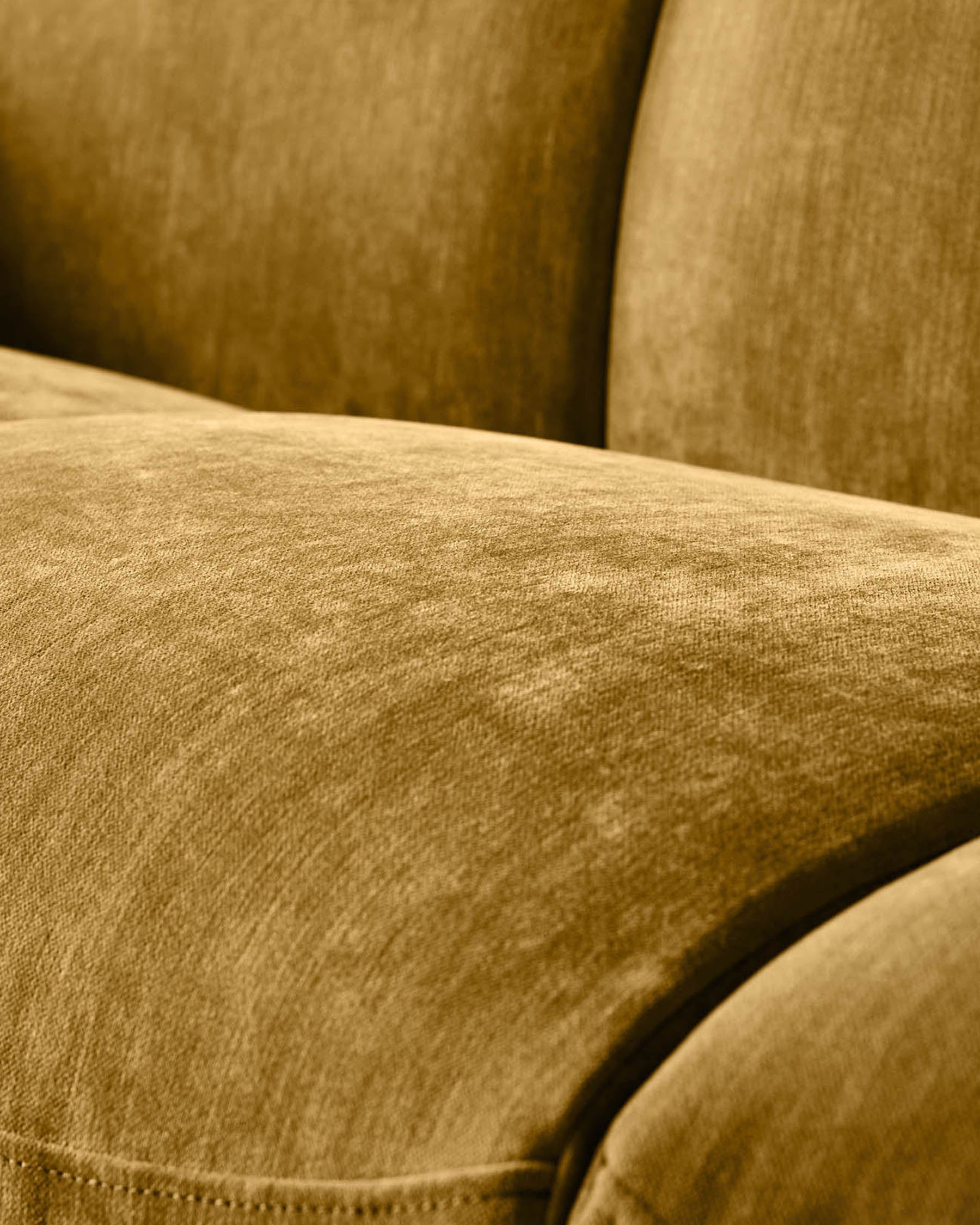 Close-up of ochre fabric on Teagan 2-seater sofa, showing texture and cushioned seating detail.