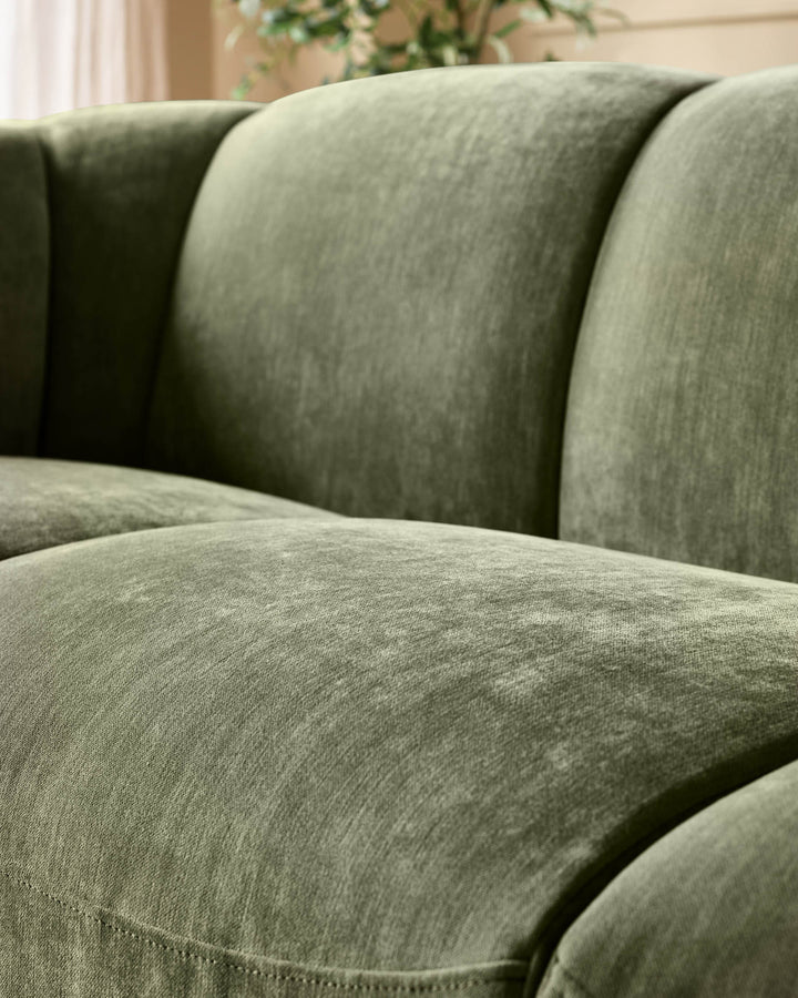 Teagan 3-seater sofa in olive green fabric, close-up of cushioned seat and rolled armrests.