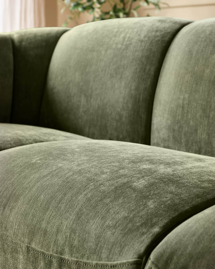 Teagan 3-seater sofa in olive green fabric, close-up of cushioned seat and rolled armrests.