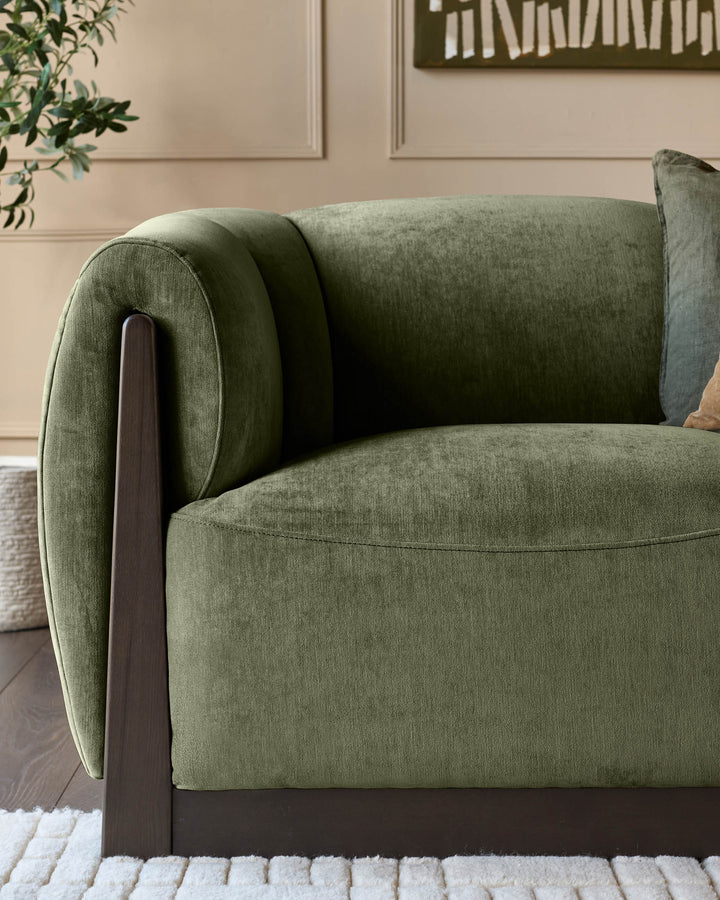 Teagan 2-seater sofa in olive green fabric with rolled arms and dark wooden legs, shown from a side angle.