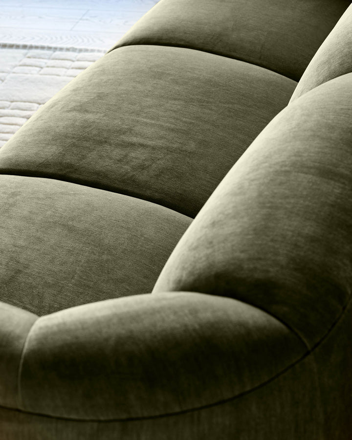 Teagan 3-seater sofa in olive green fabric, close-up detail showing plush cushions and curved armrest design.
