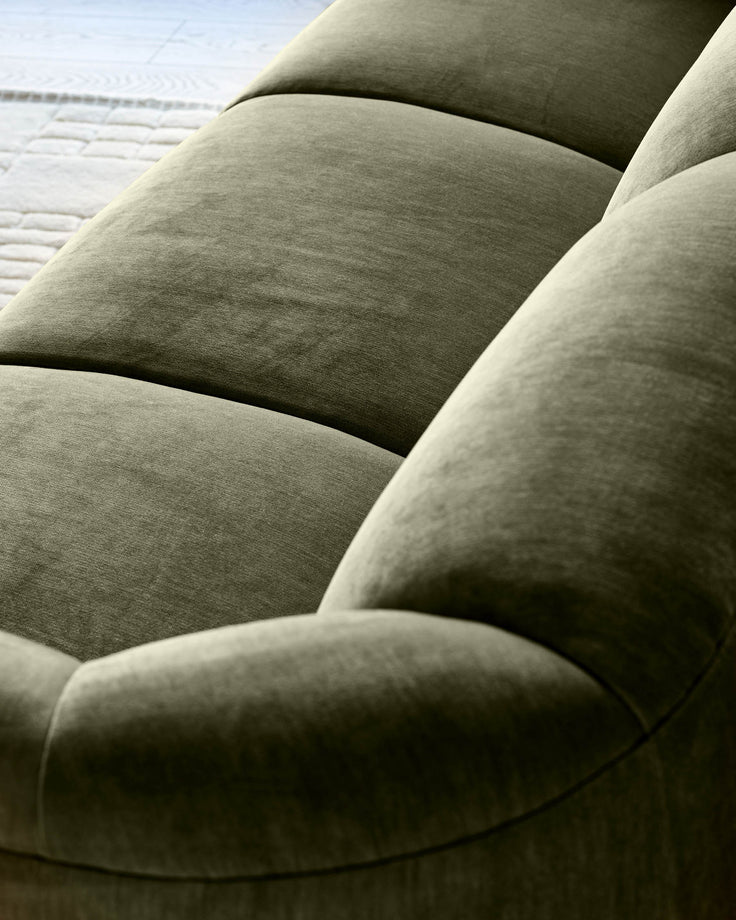 Teagan 3-seater sofa in olive green fabric, close-up detail showing plush cushions and curved armrest design.