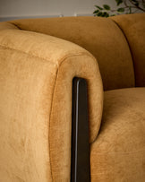 Teagan 2-seater sofa in ochre fabric with dark wooden armrest detail, angled close-up view.