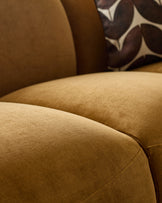 Close-up of Teagan 3-seater sofa in ochre fabric, showing textured weave and curved armrest detail.