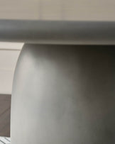Close-up of white curved edge detail on dark grey garden dining table