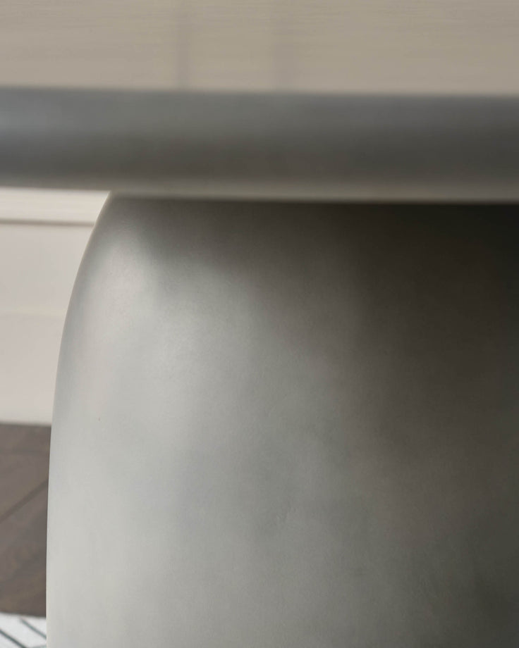Close-up of white curved edge detail on dark grey garden dining table