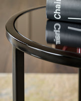 Smoked mirror tray table with black frame, curved edges, shown from a close-up side angle.