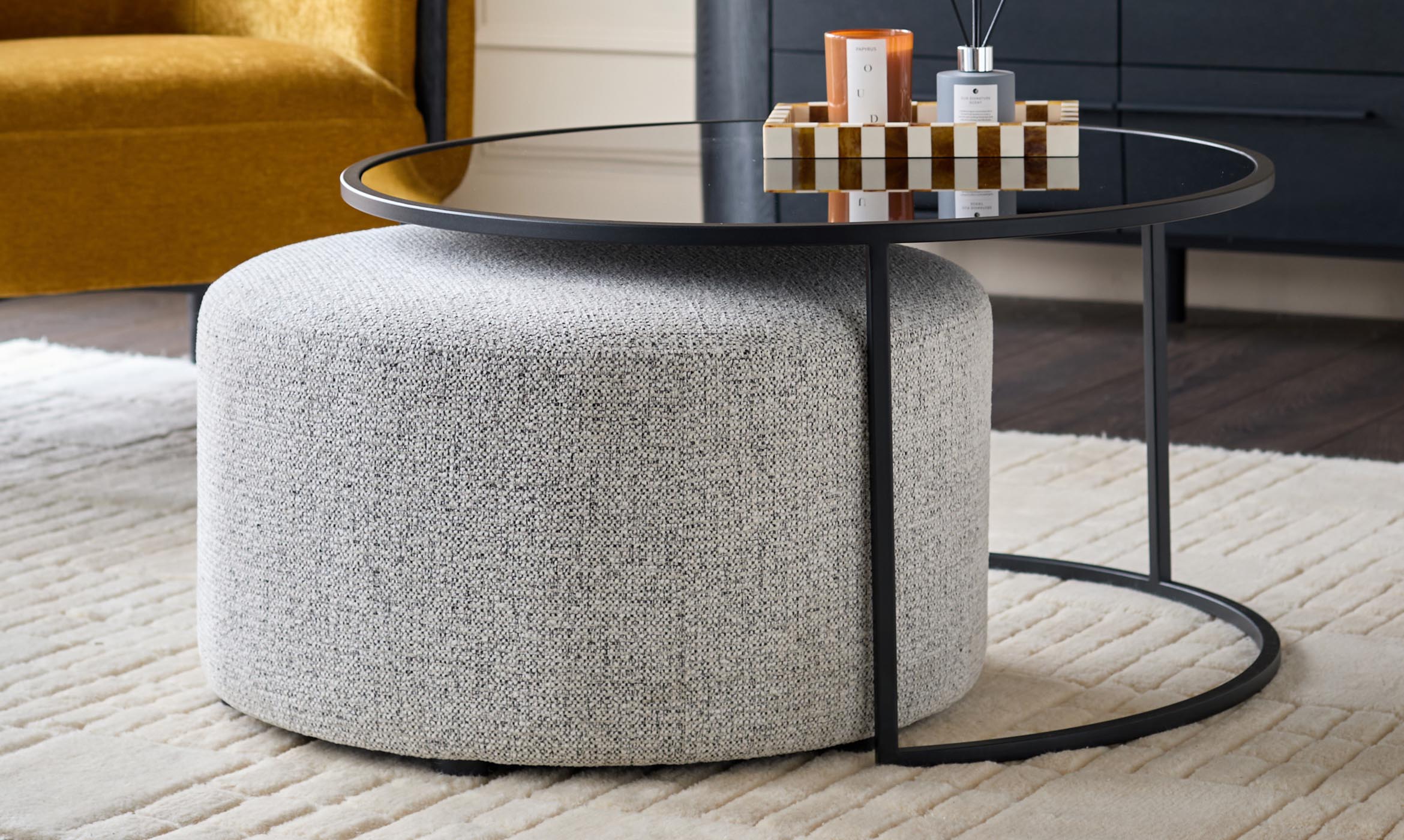 Thea smoked mirror coffee table and light grey fabric pouffe set