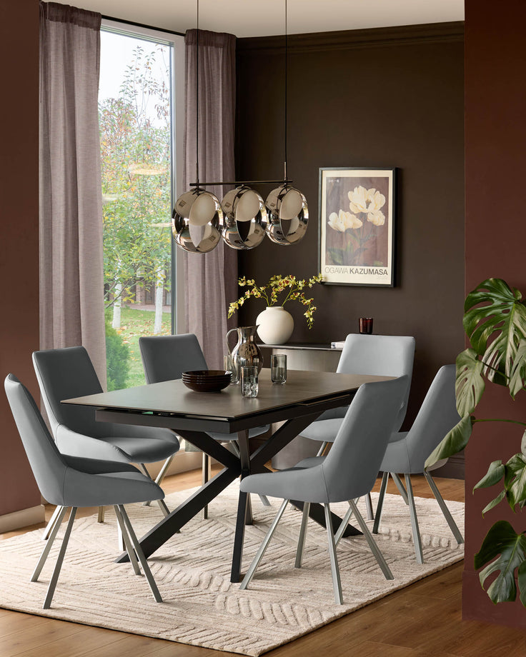 Theo mid-grey faux-leather dining chair with metal legs, shown in contemporary dining room setting around black table.
