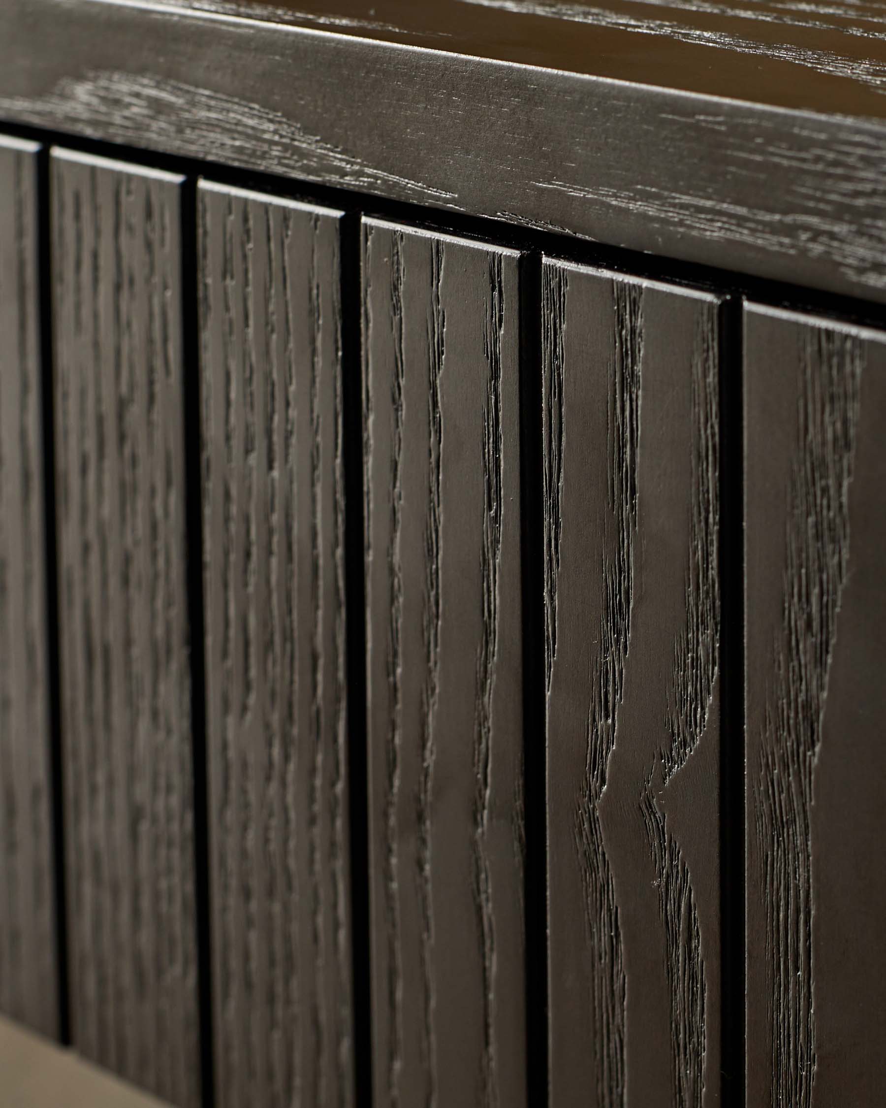 Close-up of a dark wood cabinet with vertical panelling and a sleek, modern design. Minimalist and stylish storage.