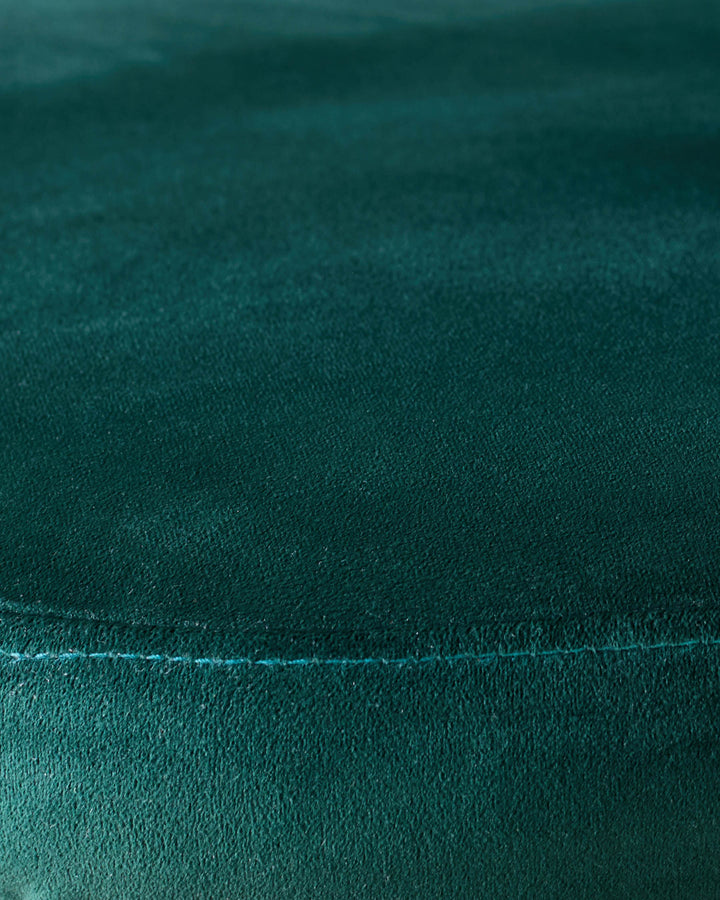Dark green velvet fabric close-up showing seam detail and plush texture of Trinny dining chair.