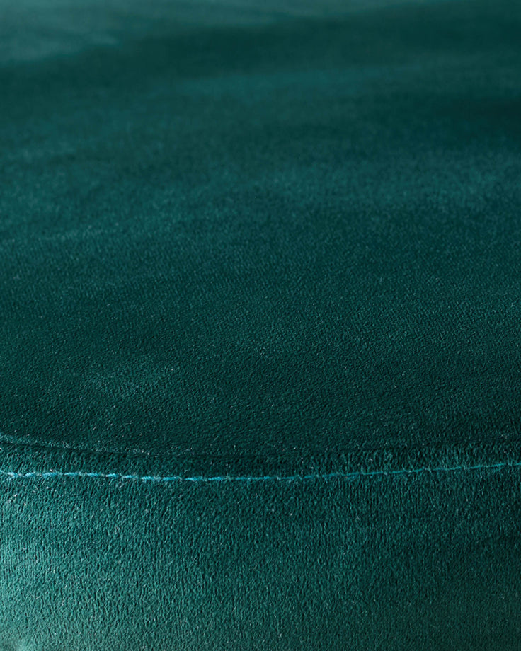Dark green velvet fabric close-up showing seam detail and plush texture of Trinny dining chair.