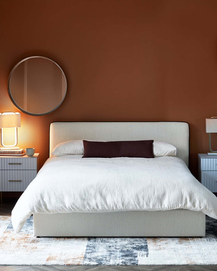 Bedroom featuring a double bed, bedside tables, lamps, a rug and a round mirror, showcasing a modern and cosy design.