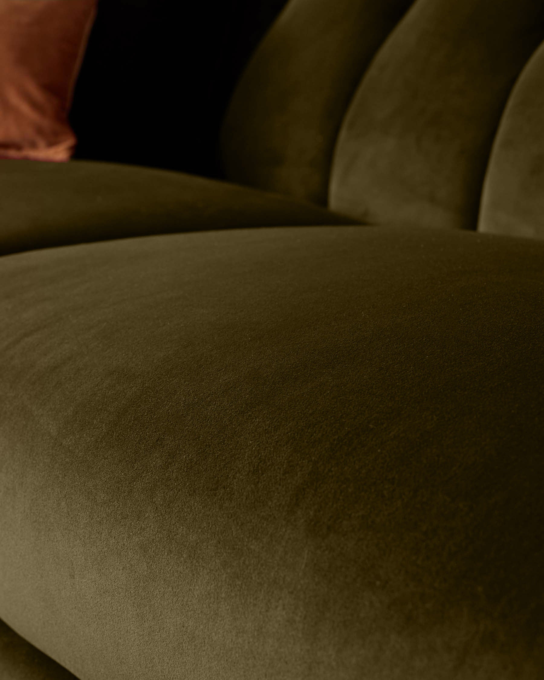 Valentina 3-seater sofa in olive green recycled velvet, close-up of curved armrest and seat cushion detail.