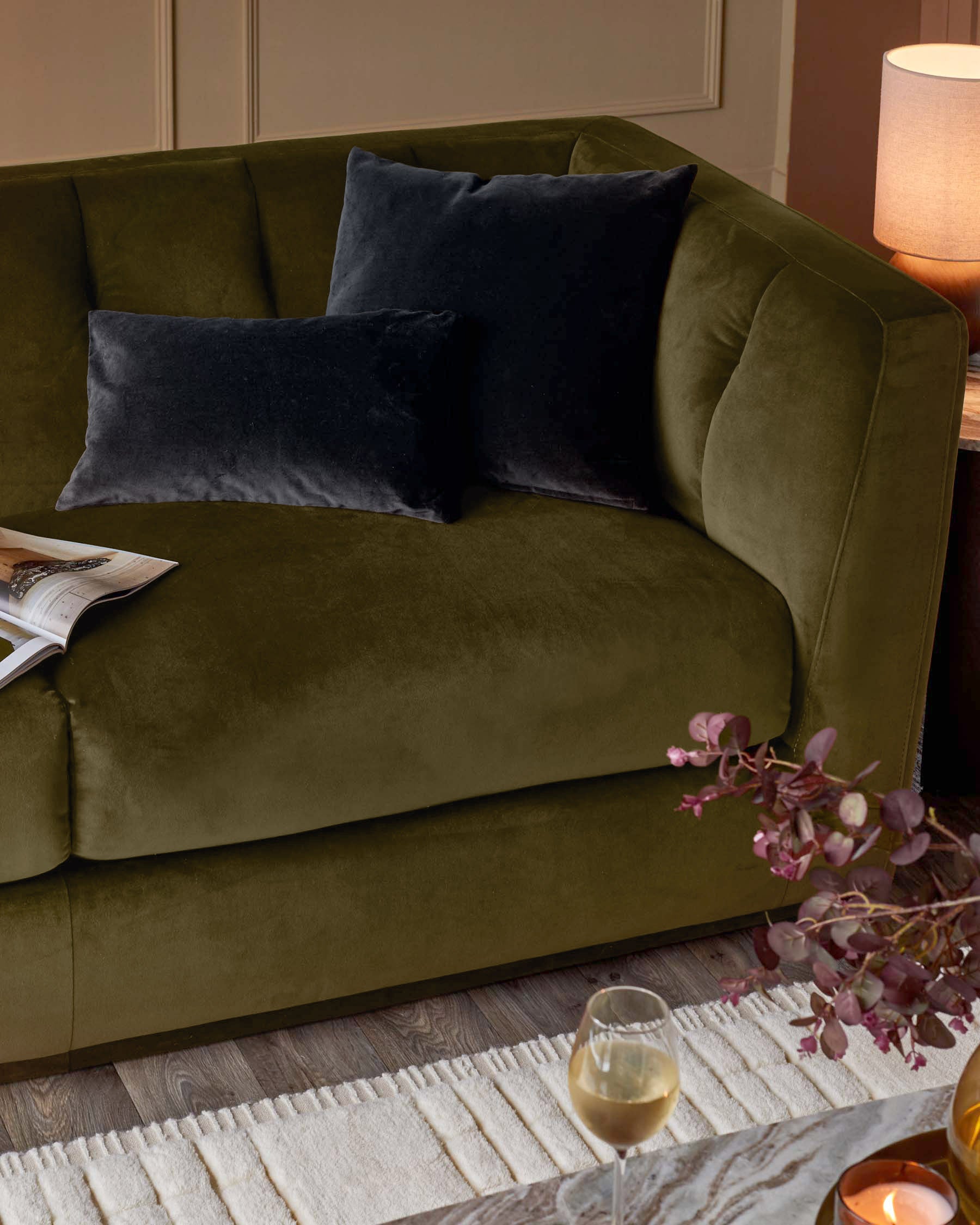 Valentina 3-seater sofa in olive green recycled velvet with navy blue cushions, styled in a modern living room setting.