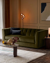 Valentina 3-seater sofa in olive green recycled velvet, shown in a styled living room setting with pillows and warm lighting.