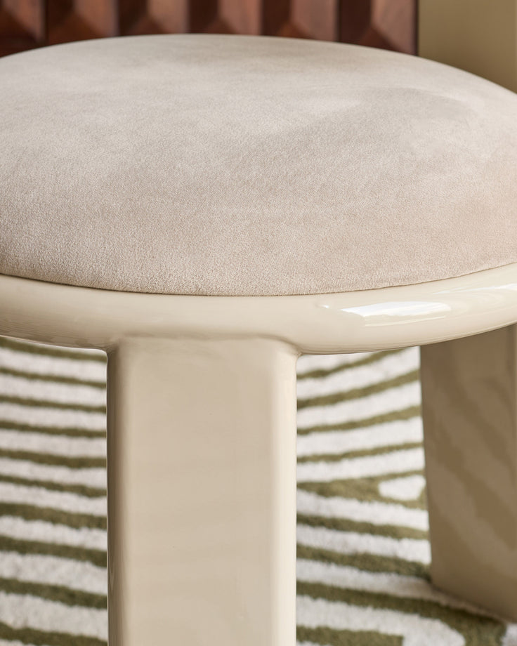 Valerie dining chair in champagne velvet, close-up of rounded seat with cream base and striped upholstered back.