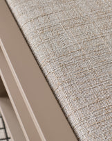 Close-up of natural beige textured fabric on Verano lounge chair seat, showing woven upholstery detail.