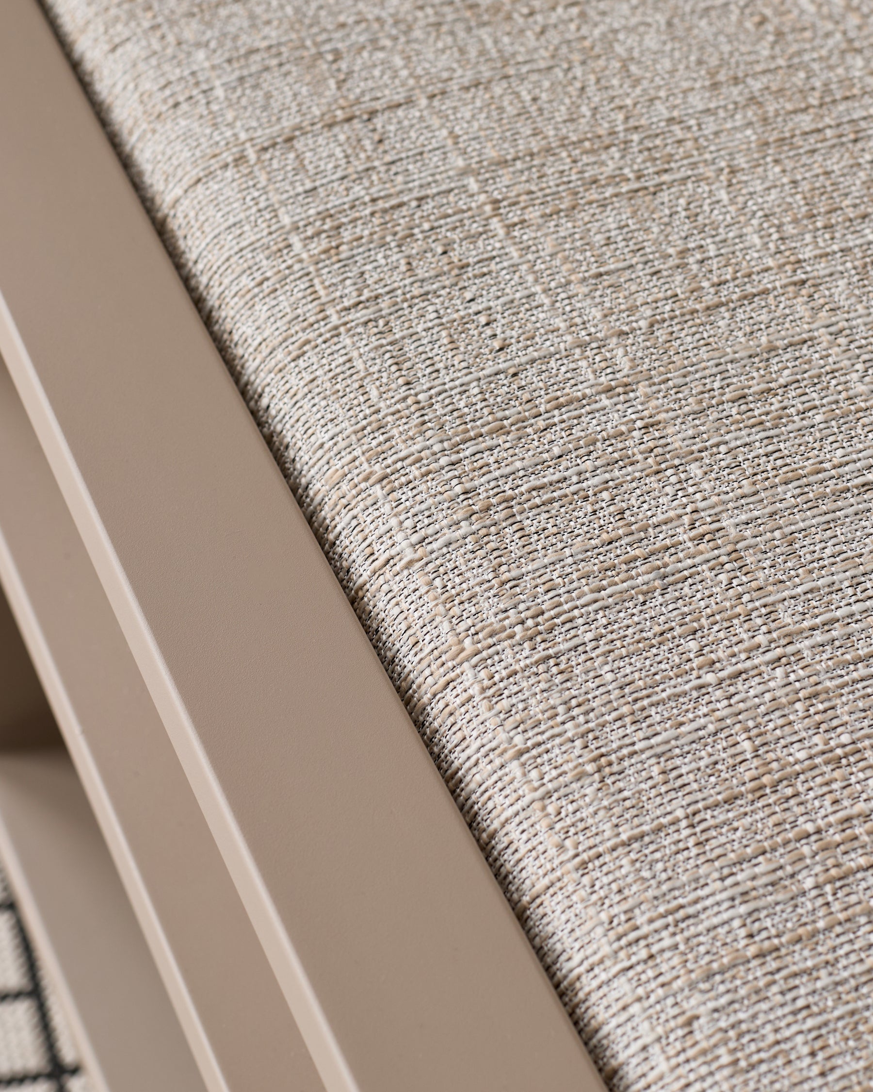 Close-up of natural beige textured fabric on Verano lounge chair seat, showing woven upholstery detail.