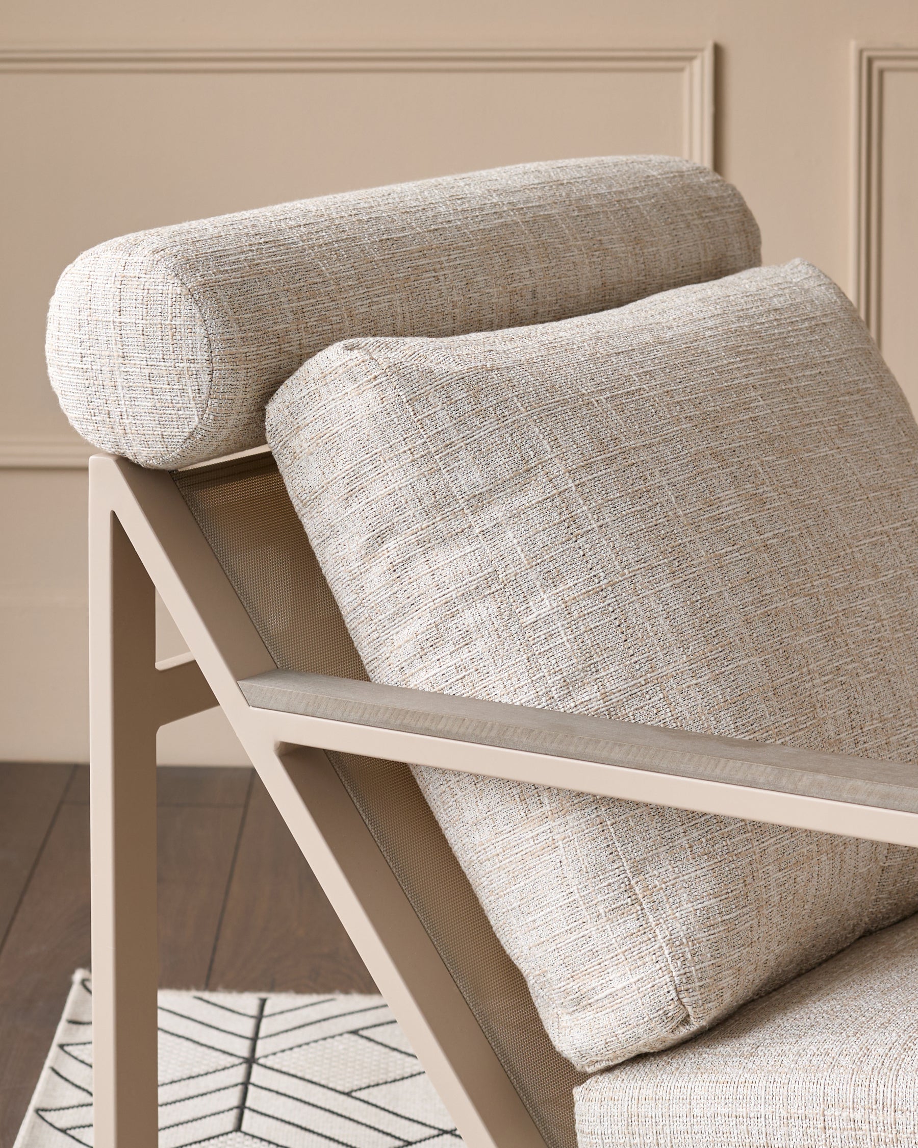 Verano garden lounge chair in natural textured fabric with cylindrical neck pillow and rectangular lumbar support pillow.