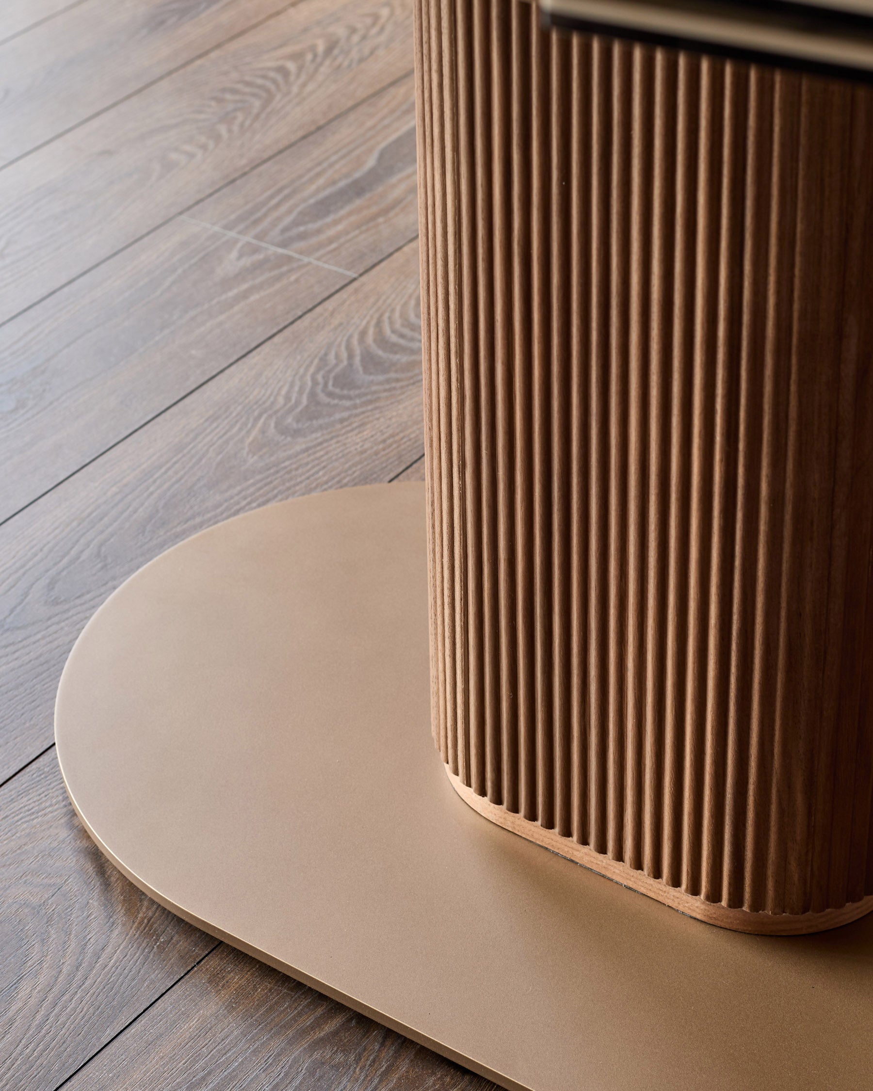 Vidal extending dining table with natural ceramic top and fluted wood base on wooden floor.