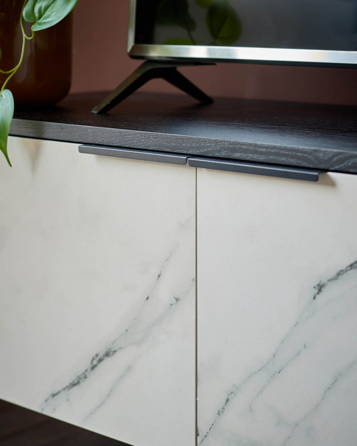 Winslow TV unit with marble-effect ceramic doors and dark wood top, showing integrated handle detail.