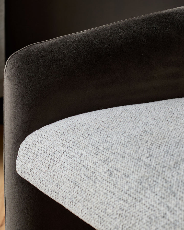 Wren cantilever dining chair detail showing grey fabric seat and dark chocolate velvet backrest, close-up side view.