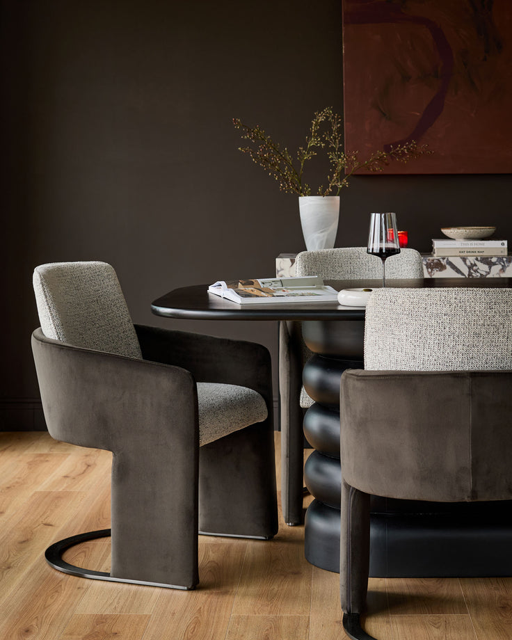 Wren cantilever dining chair in grey velvet and dark chocolate, shown in a styled dining room setting.