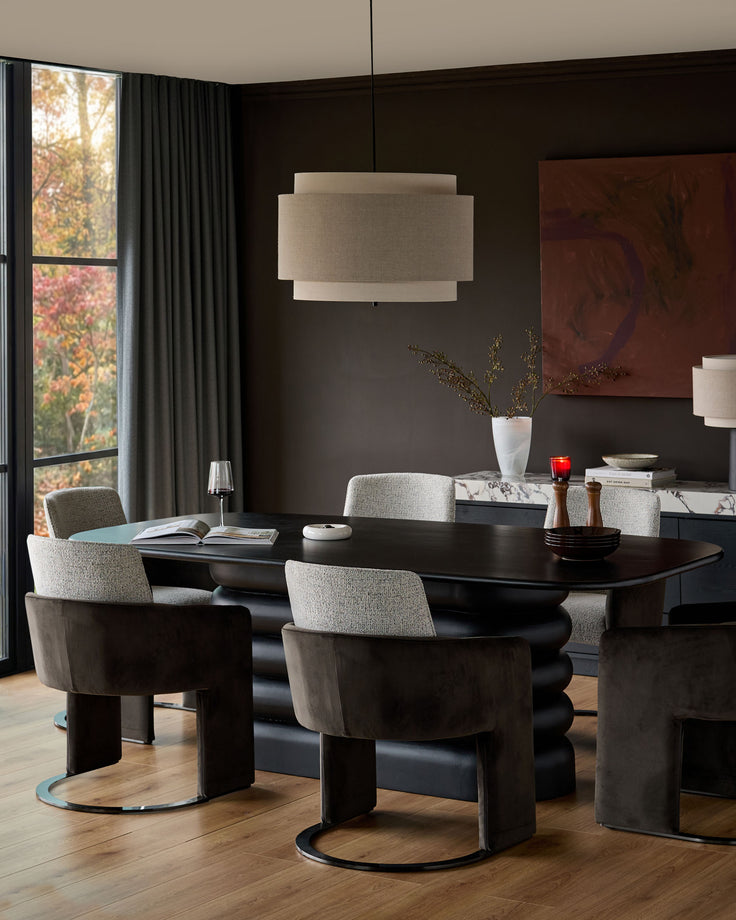 Wren Cantilever Dining Chair in grey fabric and dark chocolate velvet, shown at dining table in modern room setting.