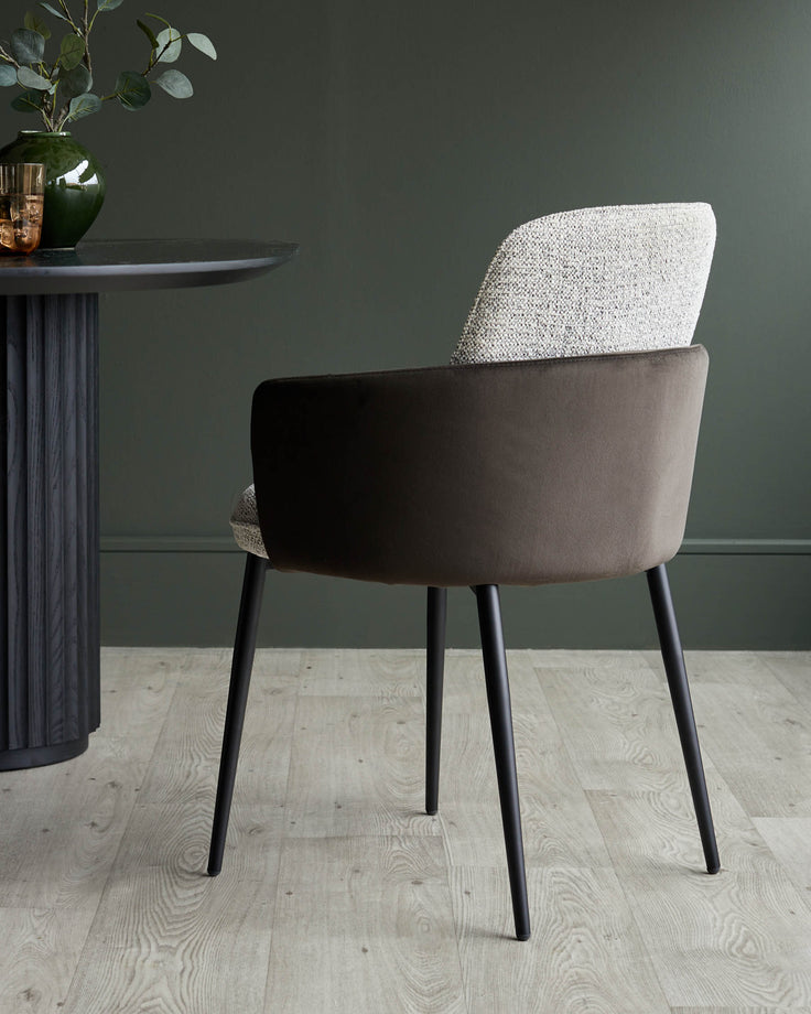 Stylish chair with a textured back and smooth, dark brown seat, paired with a modern dark table.