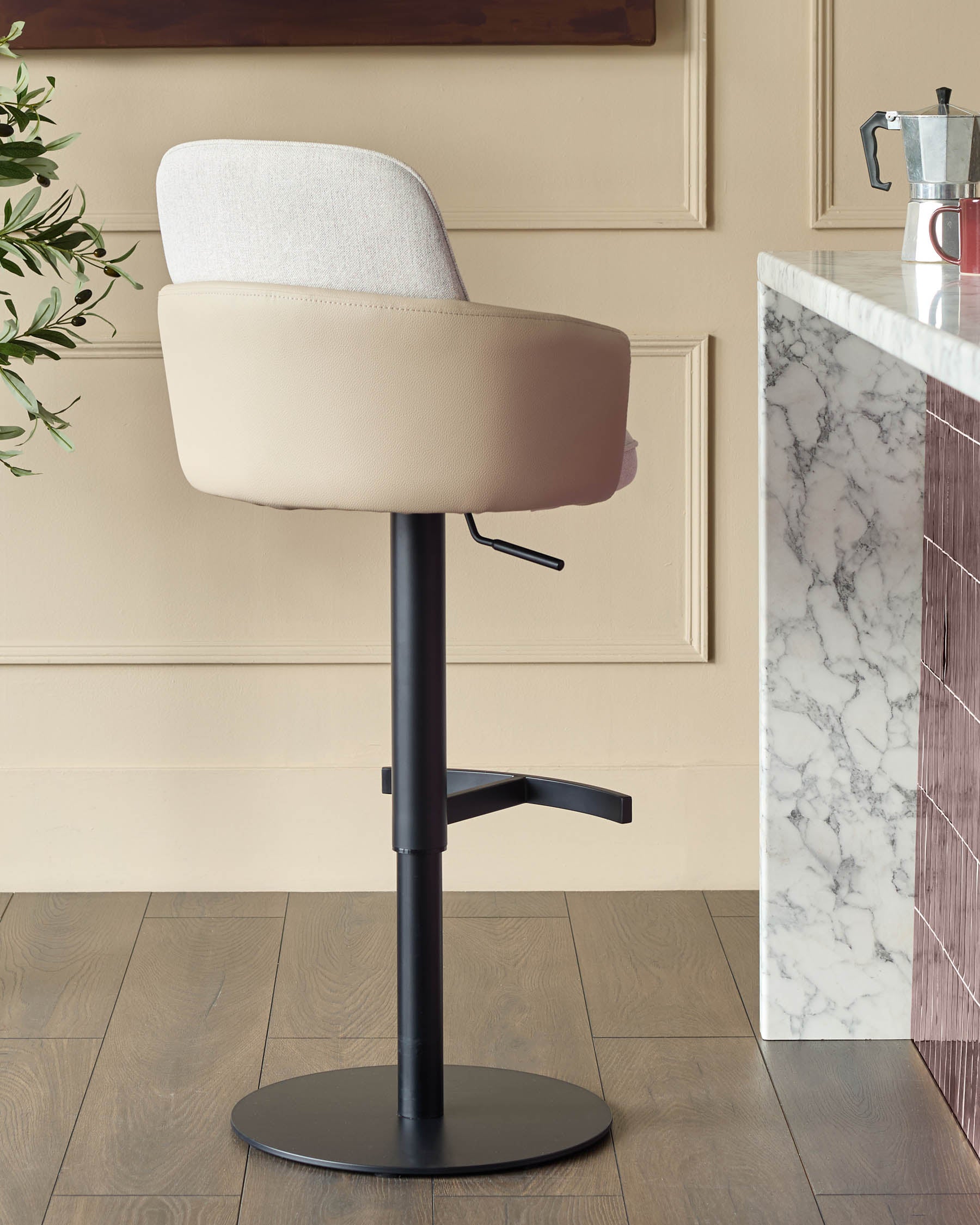 Wren gas lift bar stool in natural fabric and faux leather with black metal base, shown in kitchen setting.