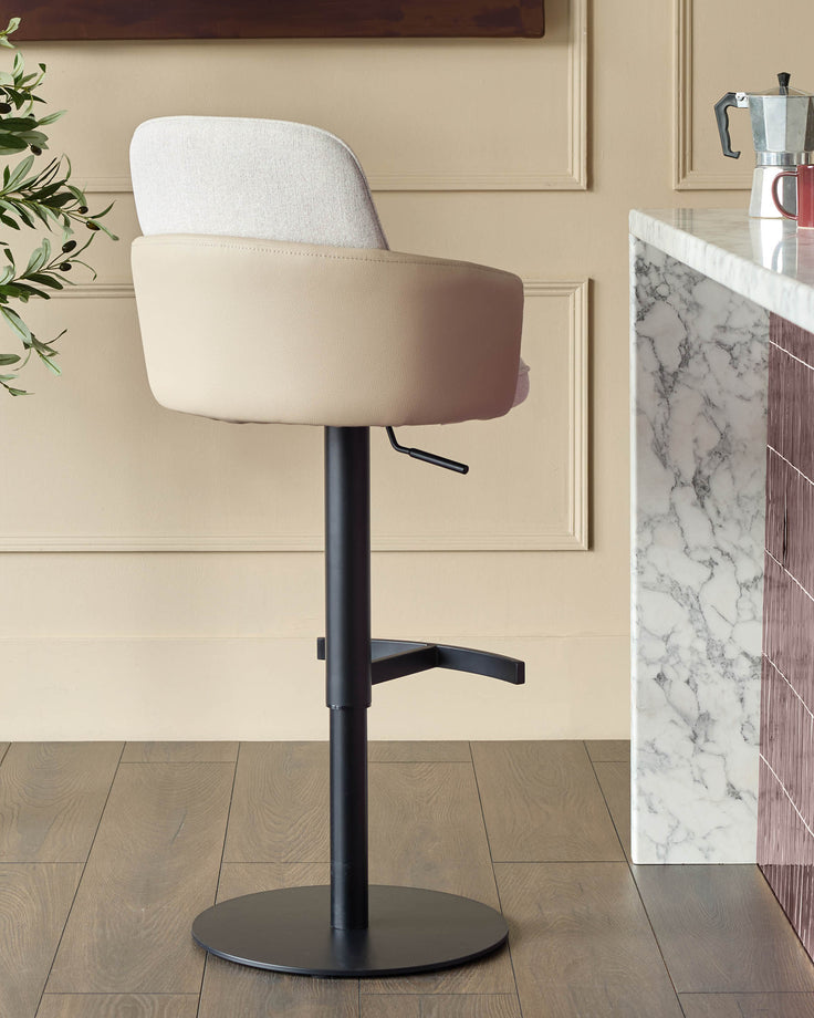 Wren gas lift bar stool in natural fabric and faux leather with black metal base, shown in kitchen setting.