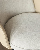Wren gas lift bar stool in natural fabric, close-up of curved seat and backrest detail.