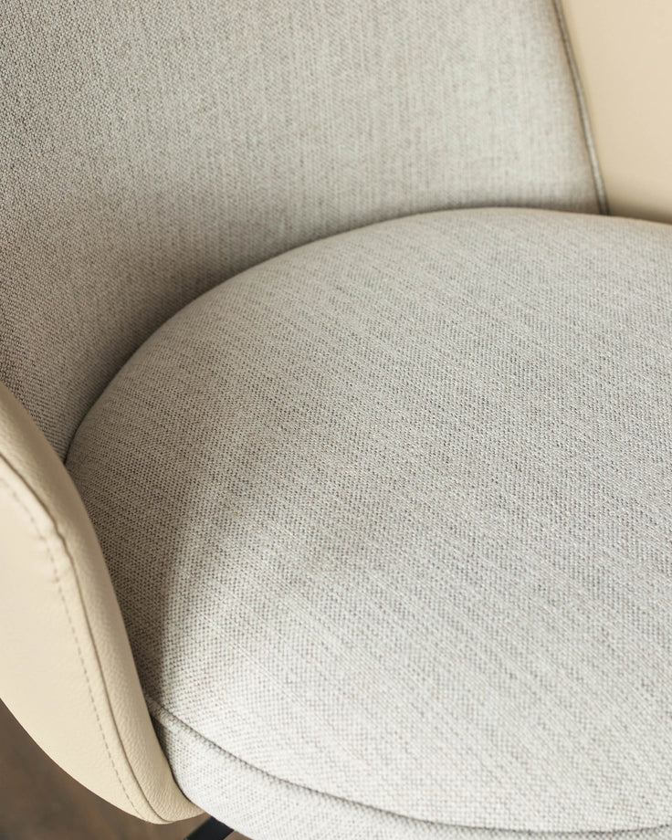 Wren gas lift bar stool in natural fabric, close-up of curved seat and backrest detail.