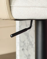 Wren gas lift bar stool with cream fabric seat, black curved footrest, and marble-effect base detail.