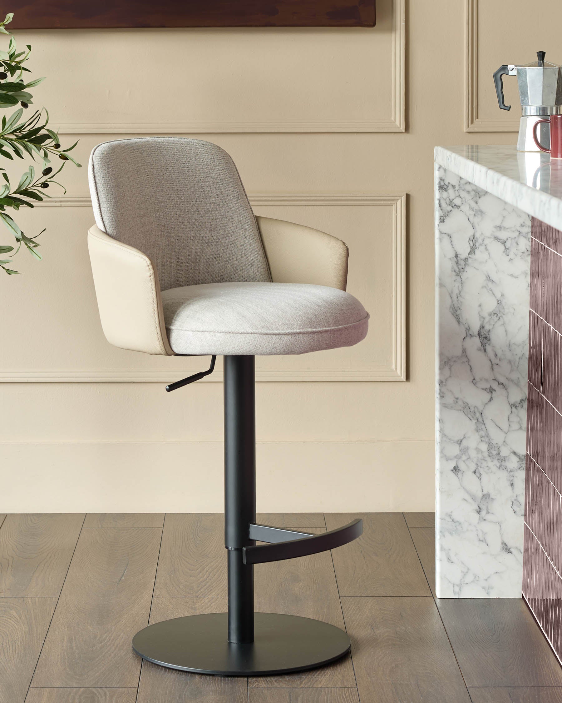 Wren gas lift bar stool in natural fabric with faux leather trim, black base, shown in cream kitchen setting.