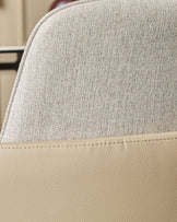 Wren dining chair showing close-up of natural fabric and faux leather seat detail with stitched seam.