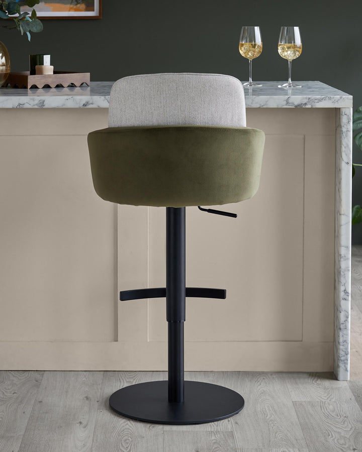 A stylish green and grey swivel bar stool with a black base, complementing a modern kitchen design.