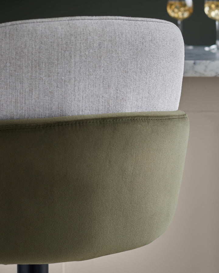 Close-up of a stylish two-tone chair with a textured light grey back and olive green curved seat.