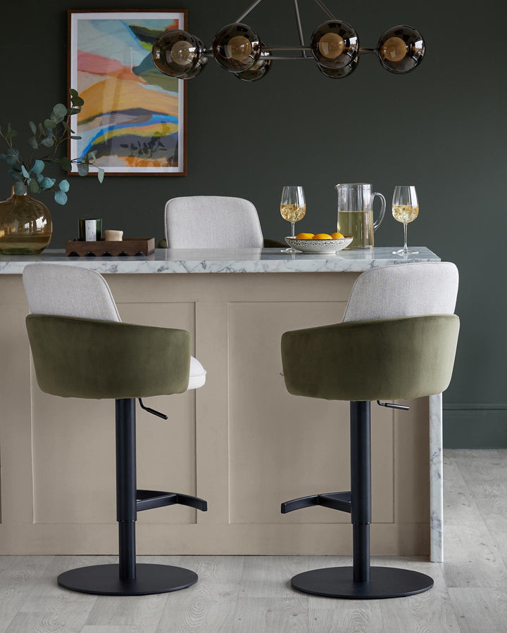 Stylish bar stools with olive green and light grey upholstery, paired with a marble-topped counter. Modern, sophisticated design.