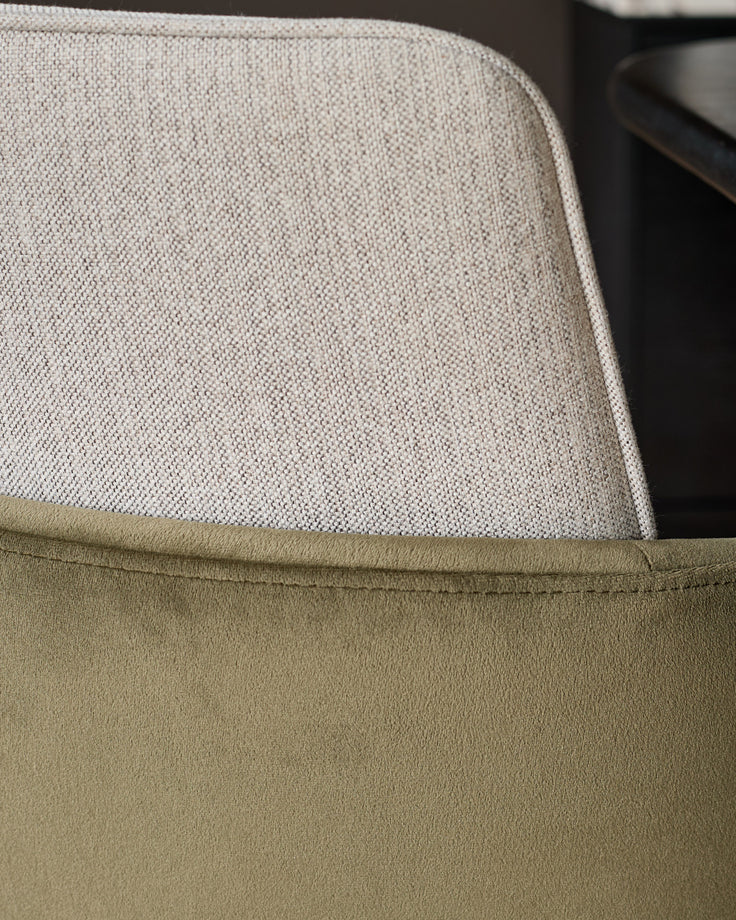 Wren cantilever dining chair showing natural and olive green velvet fabrics with curved backrest detail.