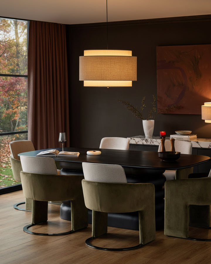 Wren cantilever dining chair in natural and olive green velvet, shown in a modern dining room setting.