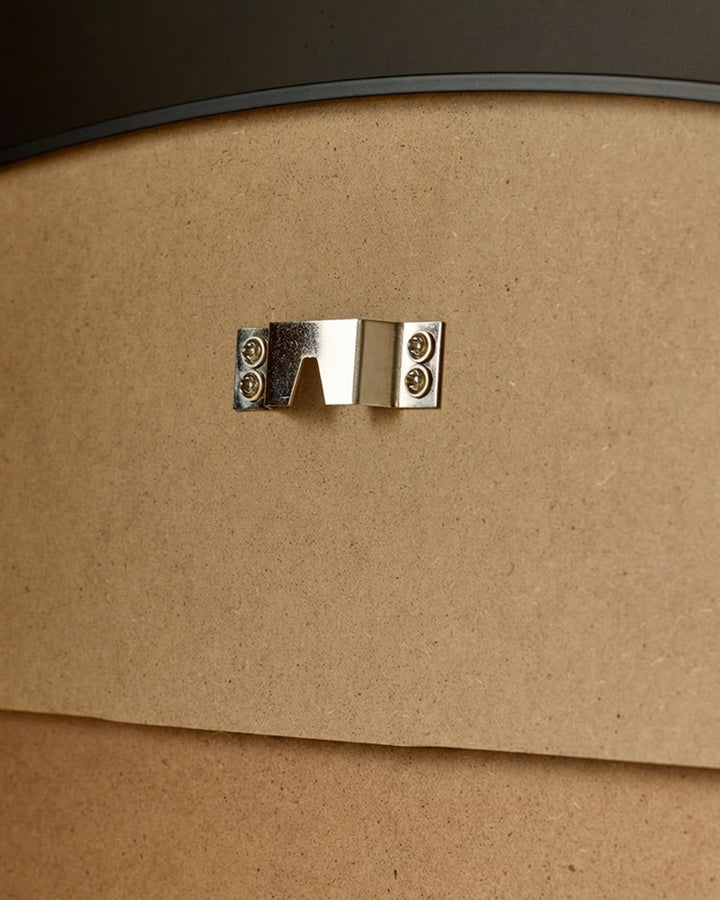 Yannis Arch Wall Mirror close-up of polished chrome handle against natural wood frame.