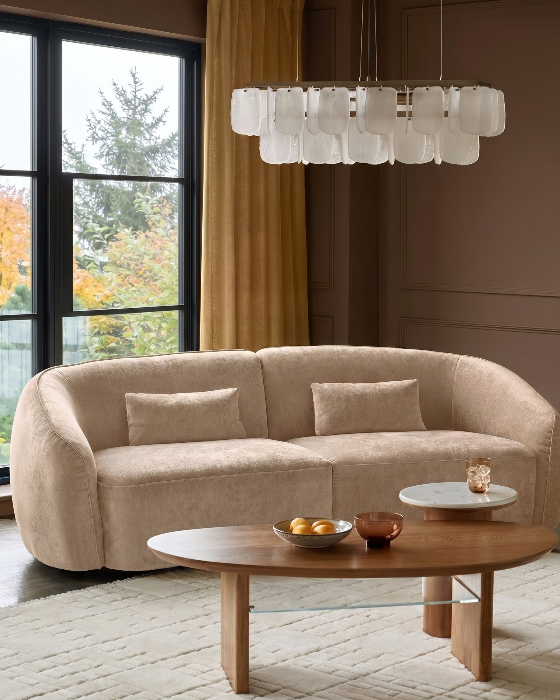 Champagne fabric curved 3-seater sofa with rounded arms and back, styled in a modern living room setting.