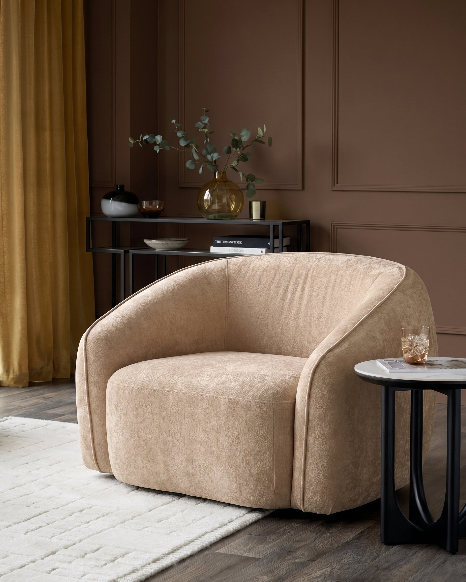 Zoey armchair in champagne fabric with curved design, displayed in a modern living room setting.