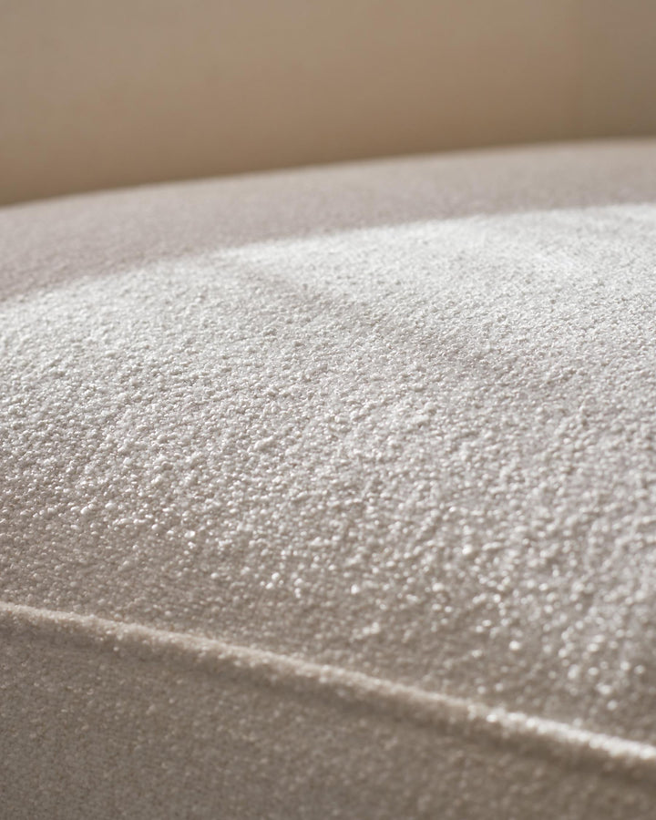 Close-up of a soft, textured, beige sofa. Perfect for a cosy living space.
