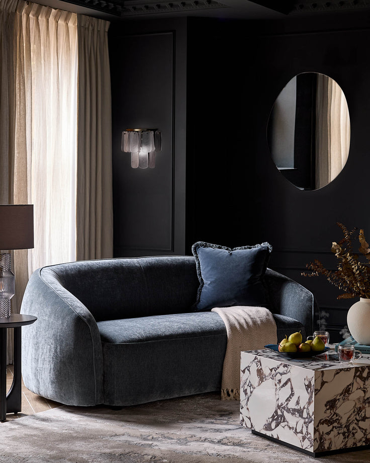 Estelle wall light with frosted glass shades mounted on black wall in modern living room setting.