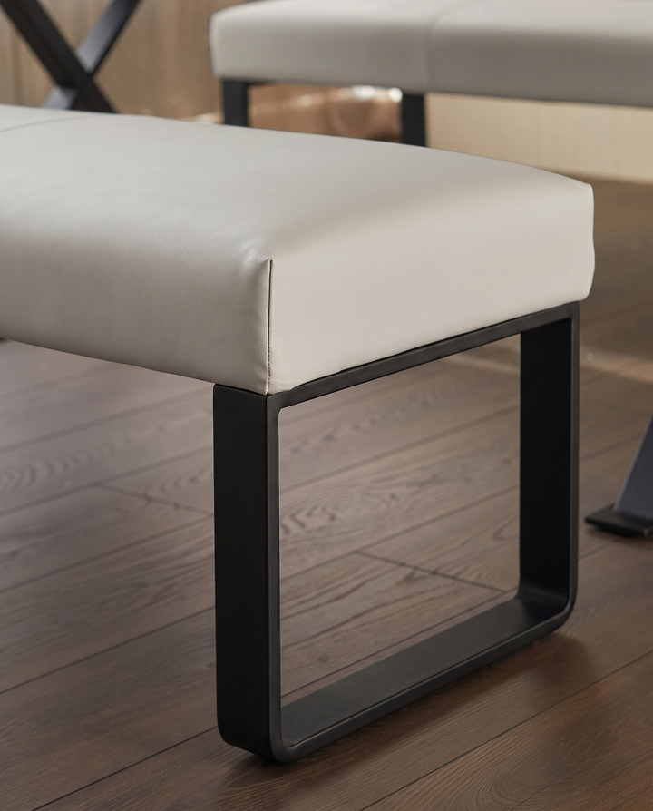 Loop 3-seater bench with light grey upholstery and black metal legs, shown from side angle on wooden floor.